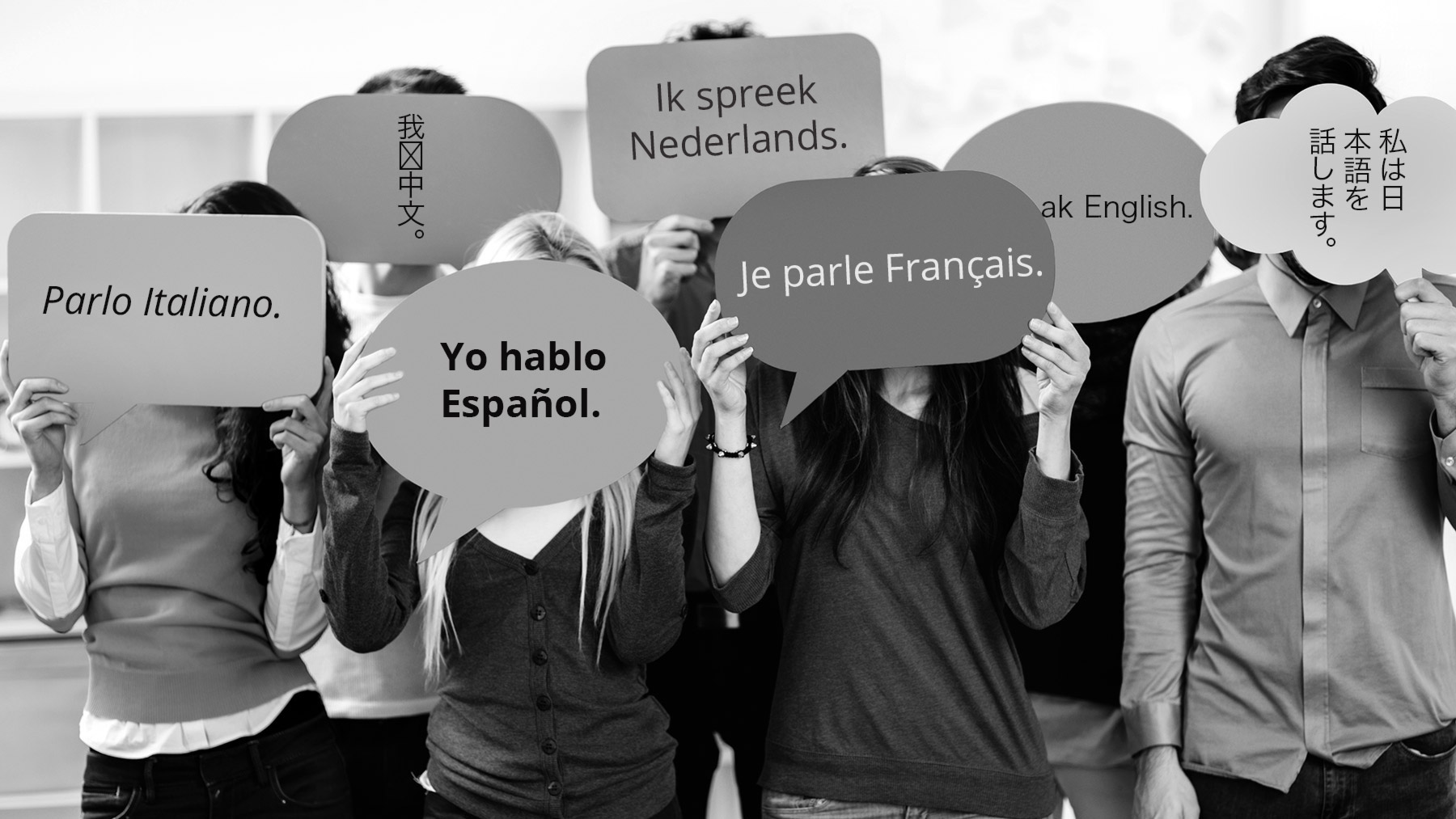 People holding different language signs