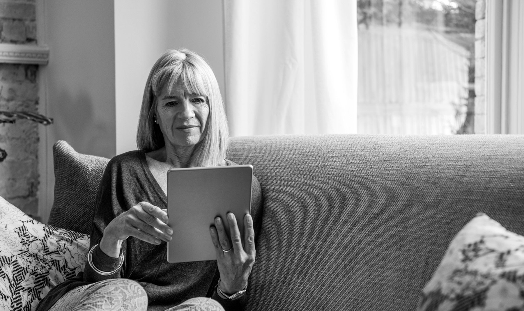 Woman on tablet sitting on couch