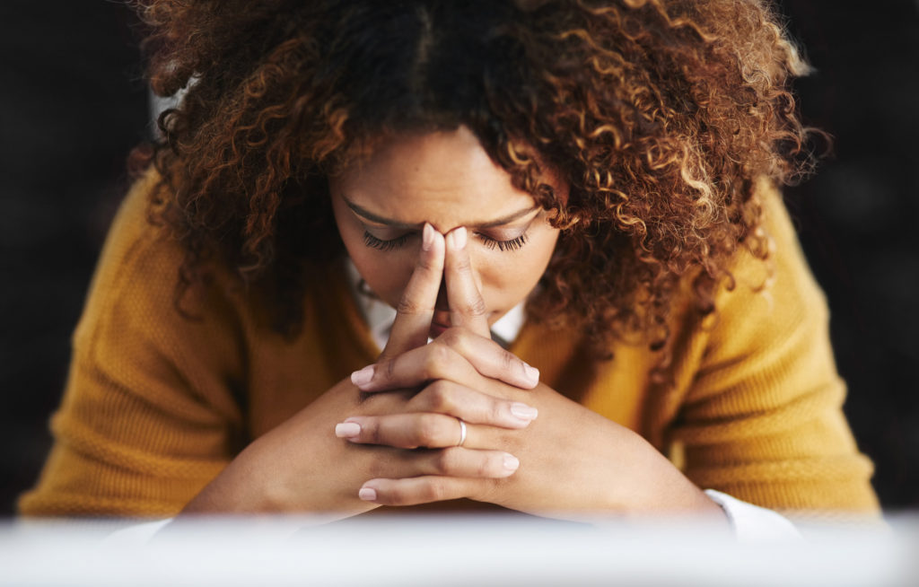 Shot of a stressed young businesswoman sitting and working in the office at work